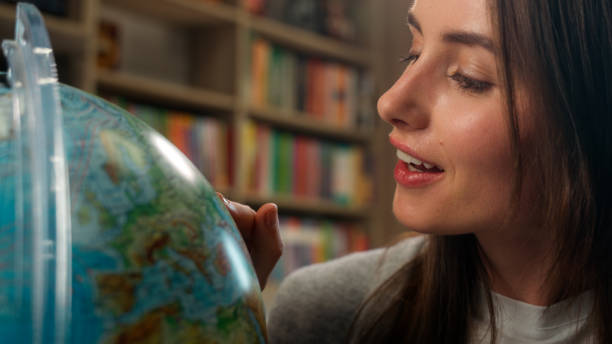 Excited Caucasian woman female girl student teacher library school geography lesson model planet earth spinning dreaming choose country vacation globe pointing finger campus learner college university Excited Caucasian woman female girl student teacher library school geography lesson model planet earth spinning dreaming choose country vacation globe pointing finger campus learner college university. High quality 4k footage finger spinning globe stock pictures, royalty-free photos & images