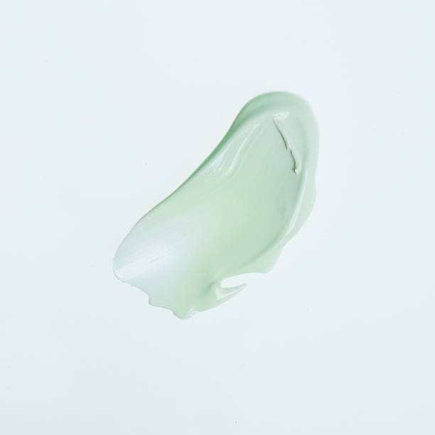 Light green blob of lotion with a soft on a plain white background The image shows a small, smooth, light green blob with a soft, flowing shape against a plain white background. The blob has an organic appearance, almost like a piece of curving glass or a soft wave. Interpretations might include themes of fluidity, tranquility, or nature, as the shape and color can evoke feelings of calmness or simplicity. makeup swipes stock pictures, royalty-free photos & images