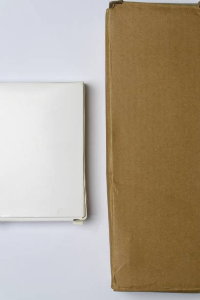 istock A white box and a brown box are placed side by side on a white surface. 2191627615