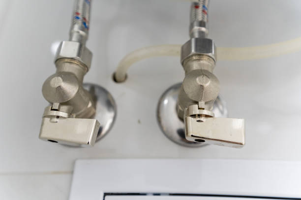 istock Closeup view of two faucets securely attached to a wall 2191628850