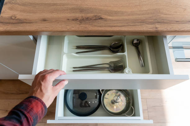 istock A person is pulling open a kitchen drawer of pots and pans 2191628862