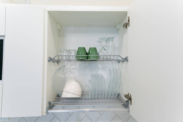 istock A kitchen cabinet that features a dish rack filled with various plates and cups 2191628928