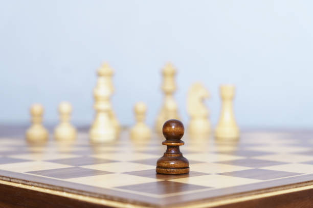 chess pawn piece in the foreground during a game with a white background