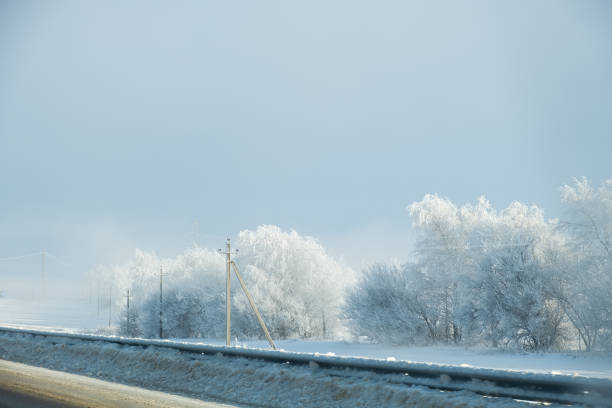 istock Winter landscape with field, trees and blue sky. long horizontal composition. 2191630580