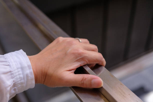 istock A woman's hand gripping a metal handrail 2191631384