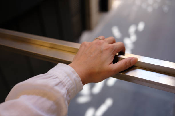 istock A woman's hand on a metal handrail 2191631395
