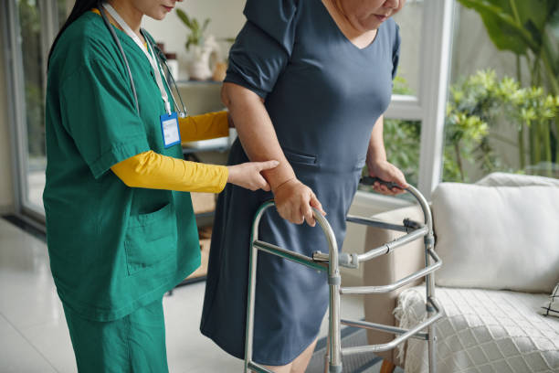 istock Nurse Helping To Walk Senior Woman 2191634813