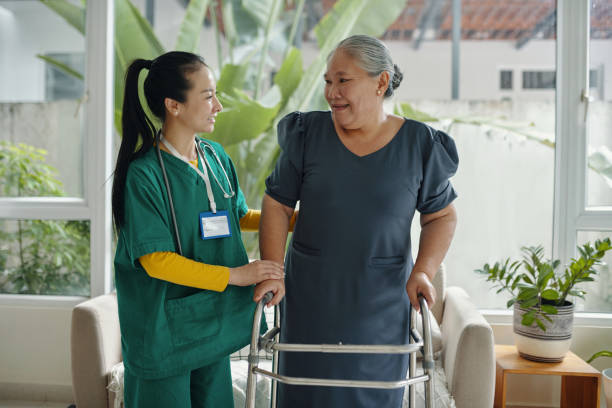 istock Social Worker Helping Senior Woman To Walk 2191634855