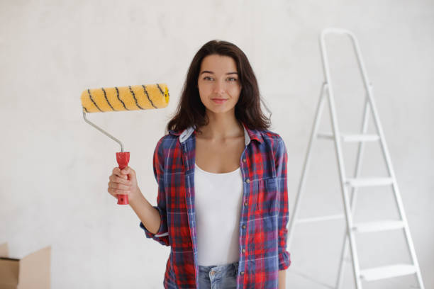 istock Smiling Woman Holding Paint Roller During DIY Home Renovation 2191638309