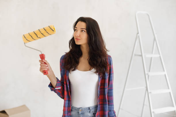 istock Woman Contemplating with Paint Roller During Home Renovation Project 2191638425