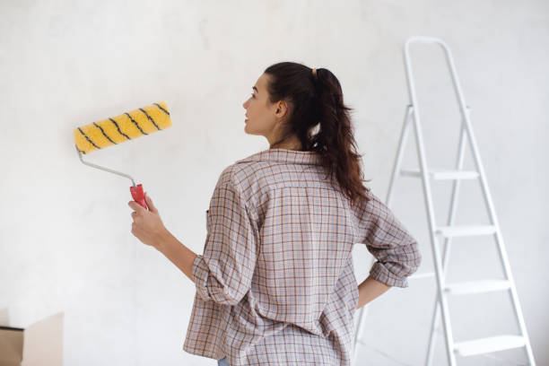 istock Woman Holding Paint Roller Ready for DIY Home Renovation Project 2191638599