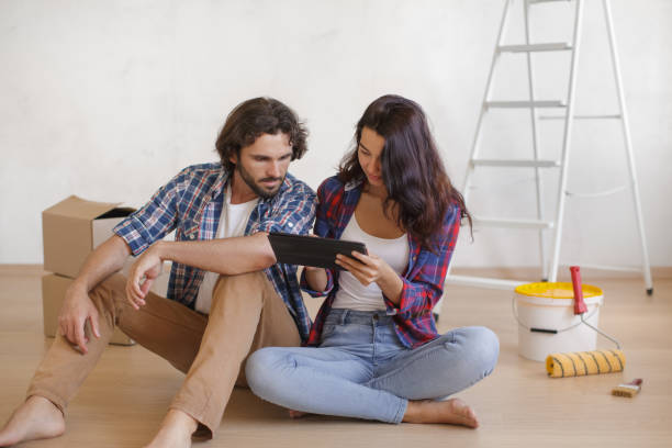 istock Focused Couple with Tablet Sitting on Floor for DIY Home Makeover 2191638728