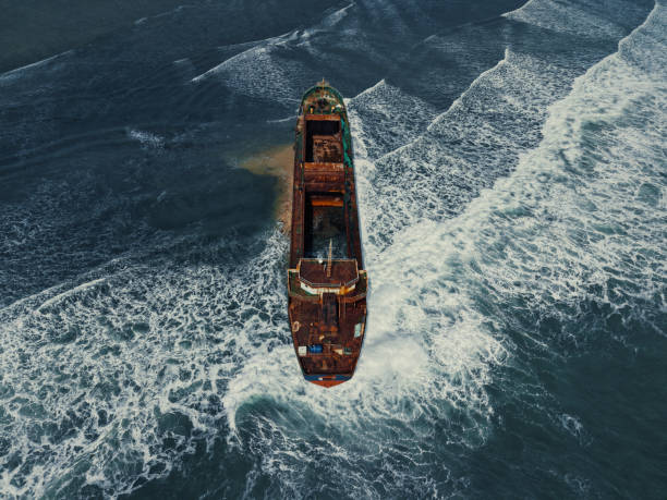 istock Aerial view, top view of old rusty stranded ship on the beach 2191640686