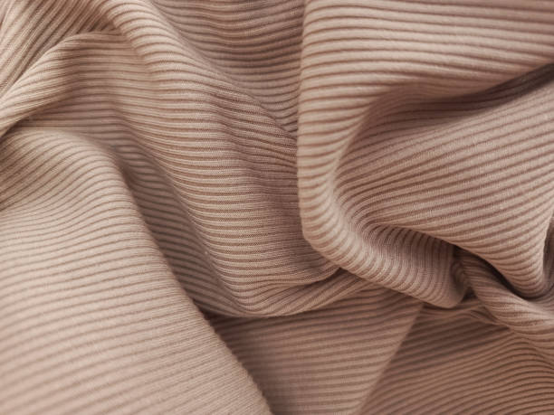 Mocha Mousse knitted fabric. Elastic fabric for sewing clothes. Background for text. Ribbed fabric. Background, space for text.