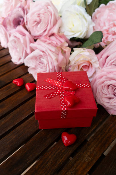 Blooming pink rose flowers bouquet with gift box, Valentine's Day background
