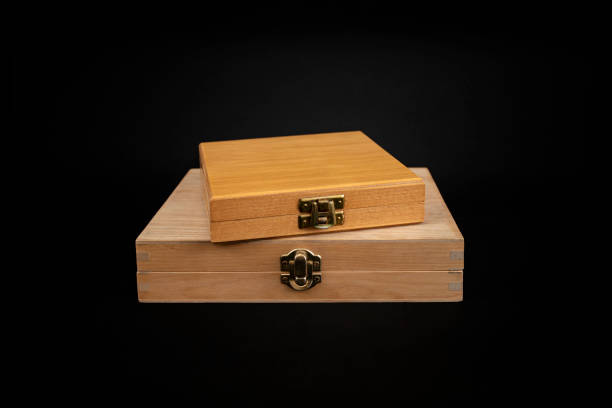 istock Wooden boxes with closed lid stacked and isolated on black  background, abstract gift concept 2191648698