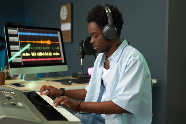 istock Musician In Headphones Playing Synthesizer 2191651550