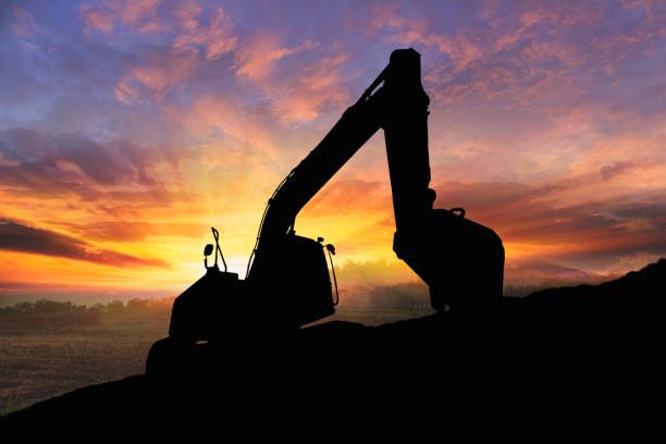 istock Crawler excavators silhouette are digging the soil in the construction site . 2191651849