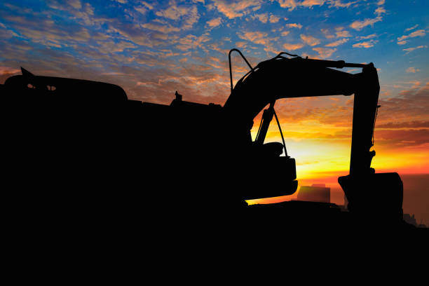 istock Crawler excavators silhouette are digging the soil in the construction site . 2191651907