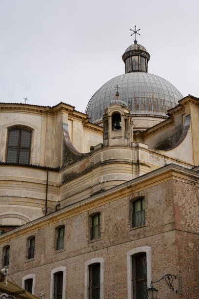 Architectural detail of an ancient Italian church with intricate stonework. Magnificent dome stands out against the sky.