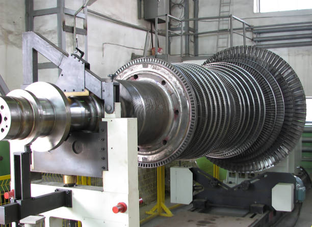 Industrial medium pressure turbine rotor on a balancing machine in a workshop. Mechanical engineering. Power engineering.