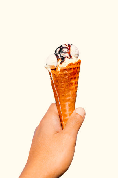 istock Man's hand holding ice cream cone. isolated with clipping path. 2191659803