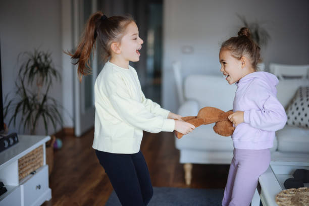 istock Kids are fighting over a toy. Conflict between sister 2191661502