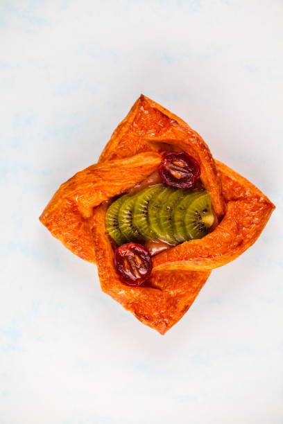 Pastry with caramelized fruit served on a light background