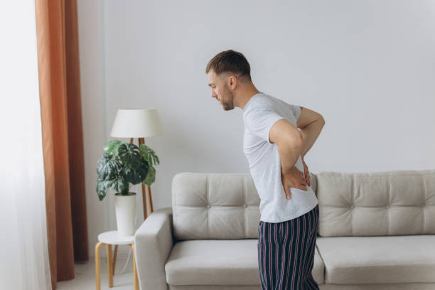 istock Back pain, kidney inflammation, man suffering from backache at home, health problems concept 2191663040