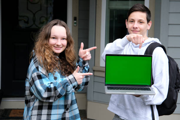 istock Cropped image of a female college student using her laptop computer and doing a school project with her friends at park. laptop white screen mockup 2191663221
