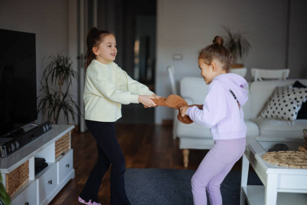 istock Kids are fighting over a toy. Conflict between sister 2191664180