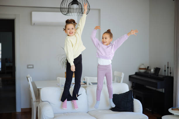istock Happy girls jumping on the sofa 2191664371