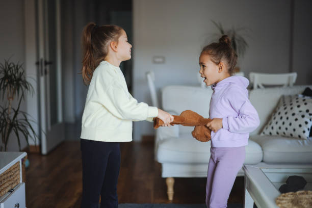istock Kids are fighting over a toy. Conflict between sister 2191664775