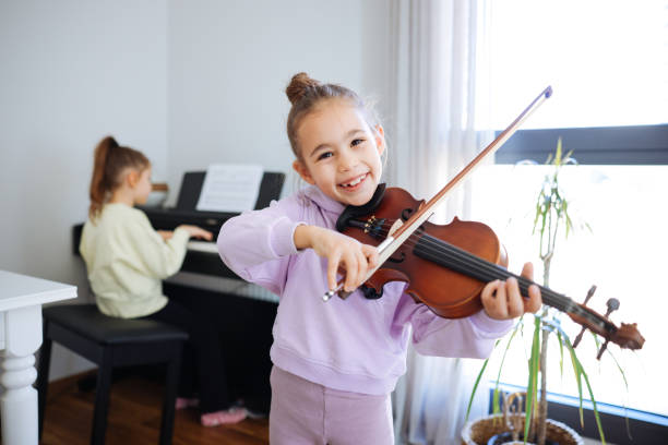istock Two sisters having fun practicing piano and violin together 2191664816