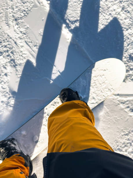 istock Snowboarder’s Feet and Shadow on Pristine Snow 2191666368