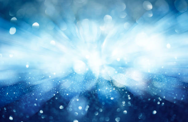istock light blue glittering Christmas lights over black background. Festive abstract glitter bokeh background 2191667924