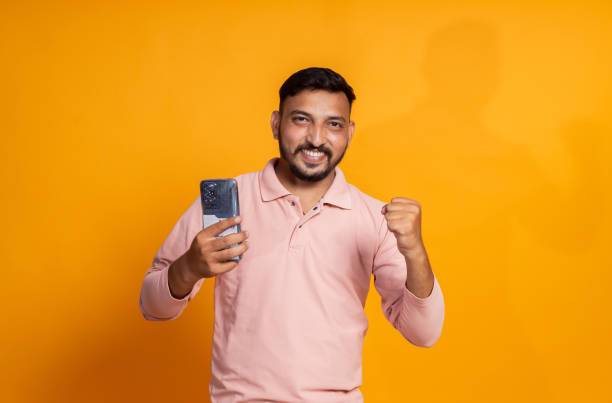 istock overexcited indian man celebrating winning with phone in hand 2191671977