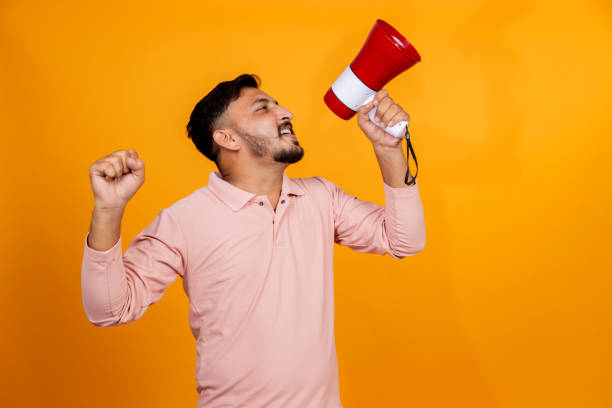istock indian man making announcement on megaphone on isolated background 2191672213