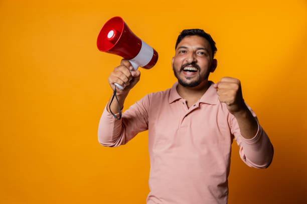 istock Overexcited Indian man with megaphone cheering on isolated background 2191672215