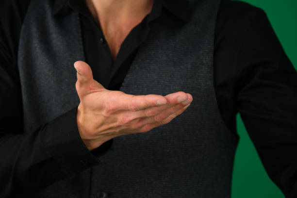 Businessman holding hand out in presentation on white background. High quality photo