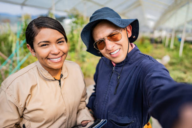 istock Farmer workers taking a selfie on a greenhouse - camera point of view 2191677793