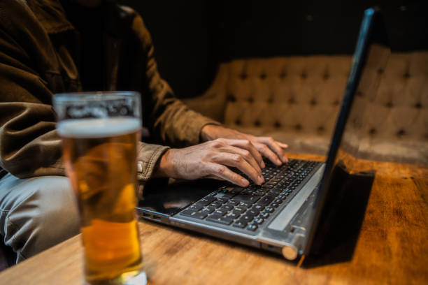 istock Close-up of a man using laptop in a bar 2191678879