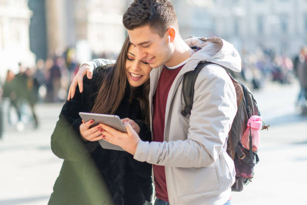 istock Young tourists couple using tablet in a city center 2191682721
