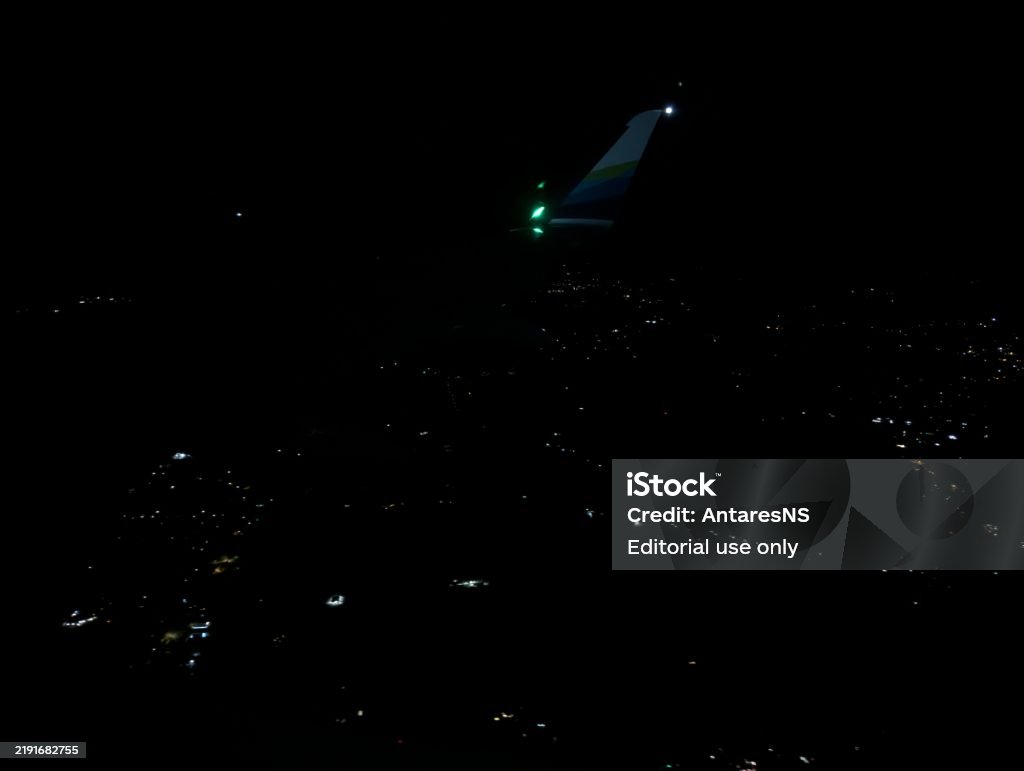 An Alaska Airlines plane lands at night. Airplane wing in the city. Portland, Oregon, USA - 09.23.2024: An Alaska Airlines plane lands at night. Airplane wing in the city. Adventure Stock Photo An Alaska Airlines plane lands at night. Airplane wing in the city. Portland, Oregon, USA - 09.23.2024: An Alaska Airlines plane lands at night. Airplane wing in the city. Adventure Stock Photo
