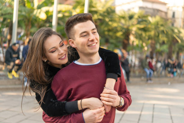 istock Young couple hugging in a city square 2191683242