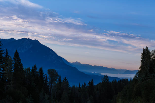 A view of the mountains and sky at sunrise in Golden, British Columbia, Canada, in the summertime.
