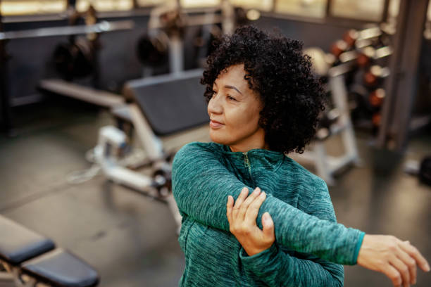istock Stretching Routine: Mature Woman Warming Up Before Fitness Training 2191686887
