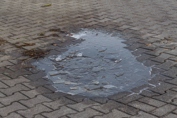 istock background, pattern. natural patterns from water and frost on the sidewalk. frozen puddle 2191687999