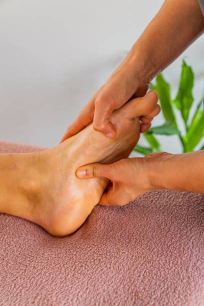 istock Hands applying pressure on the arch during reflexology massage. 2191689205