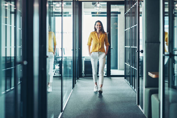 istock Young woman walking in a modern office space 2191691243